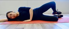 a woman laying on top of a yoga mat