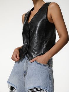 A classic tailored vest in 100% PU Leather. Can be dressed up or down and worn on its own, or over a shirt or t-shirt. Model is in MINUSEY S. ✔️ Free worldwide express shipping over $100✔️ Loved by 6,500+ customers✔️ Limited edition collections, maximum styleStay ahead of the trend with can’t-find-anywhere-else staples. Your closet will thank you 💕 * MINUSEY S = EU 34, US 2* MINUSEY M = EU 36, US 4* 100% PU Leather* Dry clean* Made in Korea - Model Height: 172cm/5'7" (US2, EU34) Cropped Leather Vest, Classic Sleeveless Leather Vest, Leather Vest With Button Closure, Black Leather Button-up Top, Black Leather Vest Vintage, Tailored Vest, T Shirt Model, Shirt Model, Leather Harness