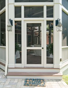 the front entrance to a house with glass doors