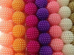 many different colored beads are stacked together