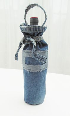 an empty denim bottle with a handle on a table