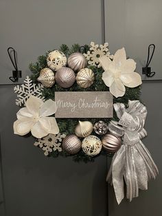 a christmas wreath with silver and white ornaments