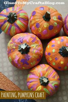 painted pumpkins sitting on top of a table