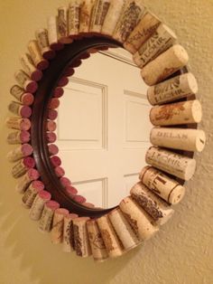 a mirror made out of wine corks hanging on the wall