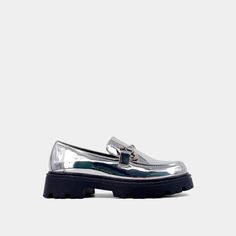 Introducing the TATIANA chunky loafers - a stunning reinterpretation of '90s-style footwear. These loafers are crafted from high-quality faux patent leather with a striking retro sole and elegant chain embellishments for a touch of sophistication. Designed as a versatile neutral anchor to complement vibrant ensembles, they add a timeless yet modern touch to your footwear collection. Chunky Loafers, Loafer Mules, Footwear Collection, 90s Style, Sneaker Heels, Boot Sandals, Mule Clogs, 90s Fashion, Sales Gifts