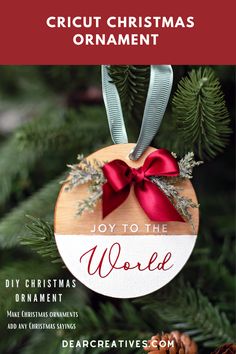 a christmas ornament hanging from a tree with the words joy to the world on it