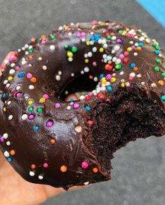 a half eaten chocolate doughnut with sprinkles