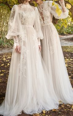 two women in white dresses standing next to each other on the same page, one wearing a