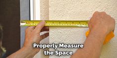 a man measuring the height of a wall with a tape measure on it's side