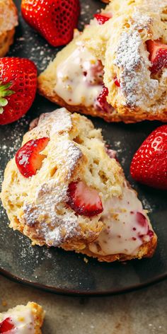 strawberry shortcakes with powdered sugar and fresh strawberries on the side, ready to be eaten