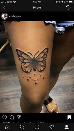 a woman's leg with a butterfly tattoo on the side of her thigh,