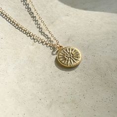 "A gorgeous gold Vergina sun coin on a simple cable chain. The pendant is double sided which makes this piece ultra care free. Beautiful on its own but layers nicely with others! Wear it with our Apollo necklace for a cohesive look!  18\" chain Easy to use clasp  Simple design matches everything  Effortless double sided pendant" Everyday Medallion Necklace With Adjustable Chain, Everyday Sun Design Pendant Necklace, Everyday Necklaces With Sun And Moon Round Pendant, Everyday Necklace With Sun And Moon Round Pendant, Gold Sun-shaped Jewelry For Everyday, Everyday Sun And Moon Design Round Pendant Necklaces, Everyday Sun And Moon Round Pendant Necklace, Everyday Sun And Moon Design Round Pendant Necklace, Gold Medallion Necklace With Sun Design