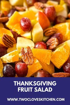 thanksgiving fruit salad with pecans, oranges, apples and cranberries on it