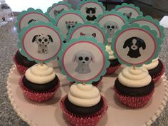 there are cupcakes with pictures of dogs on them