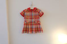 "1960's Vintage Girls Cotton/Poly Red Green Blue Plaid Mod Aline Shift Dress Dropped Waist Pleated Full Skirt Short Sleeve Flat Collar-size S label--JCPenney red flat rounded collar with white piping  *  zipper closure back of bodice metal hook and eye top of zipper  *  short sleeves with folded cuffs  *  dropped waist   *  full pleated skirt no belt  *  no lining  *no pockets modern size S Soft, mediumweight cotton/poly fabric--woven, no stretch!! Measurements Flat: Dress 12.5\" back shoulder 14.5\" across chest at bottom of armhole 15\" waist flat 15\" hip 3.25\" hem 23.75\" total length top shoulder front to hem Hand washed and hung dry and ready to wear! Excellent condition! Spots front skirt, right side seam coming undone,  Please check out all of my fabulous ETSY items on Lulavintage Retro Short Sleeve School Dresses, Retro Fitted School Dress, Retro Fitted Dress For School, Red Short Sleeve School Dress, Preppy Red Cotton Dress, Red Preppy Cotton Dress, Retro Cotton School Dress, Zipper Shorts, Skirt Short