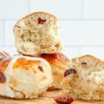 several rolls with cream cheese and raisins on a cutting board