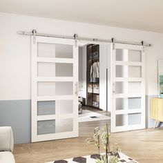 a living room filled with furniture and sliding doors