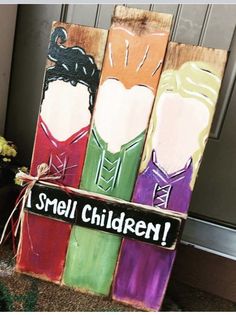 a wooden sign that says, i smell children with three different colored haircuts