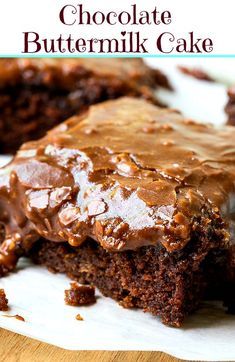 chocolate buttermilk cake on a white plate with the title in the middle above it