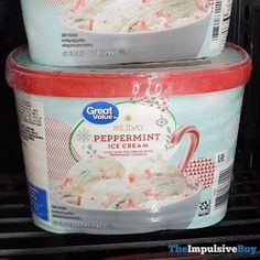 two tubs of ice cream are stacked on top of each other in the refrigerator