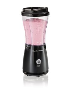 an electric blender with pink liquid in it