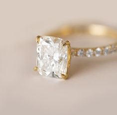 Truly one of our favorite looks of all time! A big diamond set in a petite pave diamond band - say no more 😉. We setup this ring with such a desirable shaped diamond - a magnificent 3.02 ct. lab grown elongated cushion diamond that sparkles to perfection. The diamond has zero-bow effect, perfect proportions and is incredibly bright. 3.02 ct. lab grown cushion cut diamond Color H and Clarity VS1 IGI certified 0.54 cttw. natural brilliant cut diamonds 18K yellow gold We proudly offer both natural Cushion Cut Diamond Ring For Proposal, Vs Clarity Cushion Cut Wedding Ring, Fine Jewelry, Radiant Cut Diamond Wedding Ring With Accents In White, White Radiant Cut Ring With Diamond Accents, Classic Single Cut Diamond Rings For Proposal, Timeless Cushion Cut Diamond Ring With Vs Clarity, Cushion Cut Fine Jewelry Ring With Vs Clarity, Classic Rings With Single Cut Diamonds For Proposal, White Cushion Cut Diamond Ring