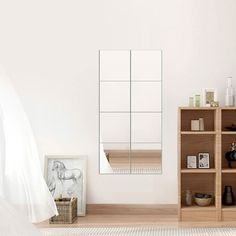 a white room with wooden shelves and a mirror