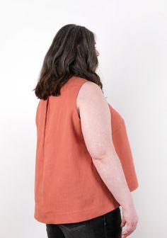 The Hadley Top is drapey, fluid, and sophisticated. It’s the semi-formal top that you can to wear to work or to throw on over your jeans for a night out. View A has a jewel neck, a pleat at the back neckline, and bracelet lengths sleeves. View B is sleeveless and features a soft v-neck. Both are subtly geometric as they have center seams in the front and back as well as a wide hem. Techniques involved include sewing straight and curved seams, setting sleeves, darts, pleating, and applying facing Sleeveless Spring Top With Button Back, Sleeveless Button Back Top For Spring, Spring Sleeveless Top With Button Back, Sleeveless Tops With Button Back For Spring, Spring Button Back Tops For Work, Button Back Blouse For Summer Workwear, Button-back Blouse For Summer Workwear, Summer Workwear Blouse With Button Back, Formal Top