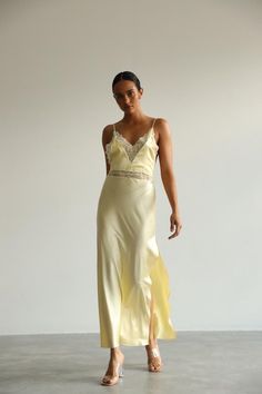 This long white Slip Dress made of soft pure mulberry silk. A V-neckline with lace, open back with adjustable spaghetti straps, meet a bias cut to fall beautifully against the body, inspiring a feminine silhouette. Effortless for both day and night, for romantic evening or as a bridal getting ready dress.   Model is 168 cm, 84/64/89 wears size XS Total length 135 cm from the shoulder  Off white color Silk V-neck Dress With Delicate Lace, V-neck Slip Dress With Delicate Straps For Wedding, Satin Slip Dress With Spaghetti Straps And Back Opening, Fitted V-neck Slip Dress With Lace Bodice, Spring Low Back Slip Dress With Bias Cut, Chic V-neck Slip Dress For Wedding Night, V-neck Delicate Lace Slip Dress For Wedding Night, Silk Low-back Slip Dress For Summer, Summer Silk Slip Dress With Low Back