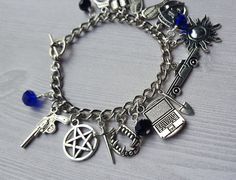 Supernatural Charm Bracelet by AlwaysBelieveJewelry on Etsy Blue Metal Charm Bracelet With Lobster Clasp, Silver Novelty Charm Bracelet, Silver Novelty Metal Charm Bracelet, Novelty Silver Metal Charm Bracelet, Personalized Black Metal Charm Bracelet, Novelty Silver Hypoallergenic Charm Bracelet, Nickel Free Black Metal Charm Bracelet, Novelty Nickel-free Metal Charm Bracelet, Nickel-free Black Metal Charm Bracelet