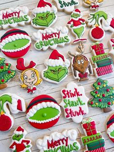 decorated christmas cookies are arranged on a white wooden surface with the words merry grin's and other holiday treats