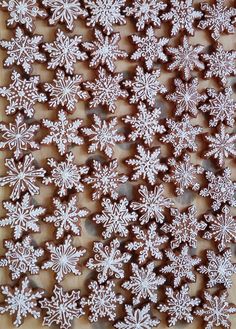 some white snowflakes on a brown table