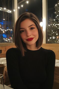 Woman with short brown hair and red lipstick smiling in a cozy, warmly lit restaurant. Brunette Bob Side Part, Bob For Short Neck, Sleek Bob Side Part, Italian Bob Side Part, Styled Bob Hair Ideas, Short Hair Inspo Straight, Bob Haircuts Straight Hair, Should Length Bob, All One Length Bob