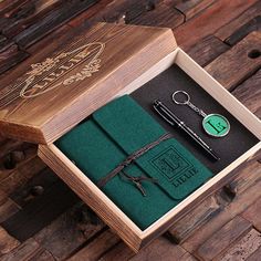 a wooden box with a pen and keychain in it