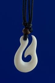 a white pendant with a black cord hanging from it's side on a blue background