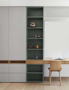 a room with a desk, chair and bookcase in the corner next to it