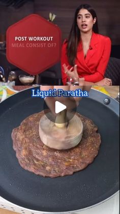 a woman in red shirt standing next to a pancake on top of a frying pan