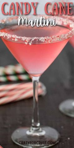 a pink candy cane martini in a coupe glass on a table with candy canes