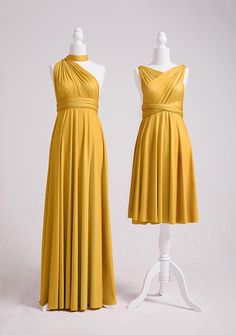 two mannequins dressed in yellow dresses, one wearing a halter top