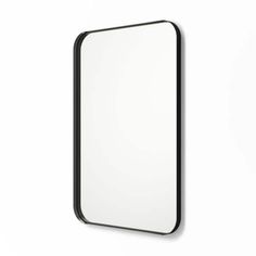 a mirror hanging on the wall with a black frame and white backgrounnd