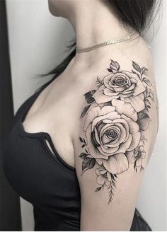 a woman with a black and white rose tattoo on her shoulder