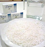 white rice in a bowl next to two boxes of dove water and a glass of water