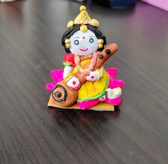 a small figurine sitting on top of a wooden table