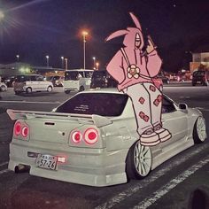 a car parked in a parking lot with a cartoon character painted on the side of it