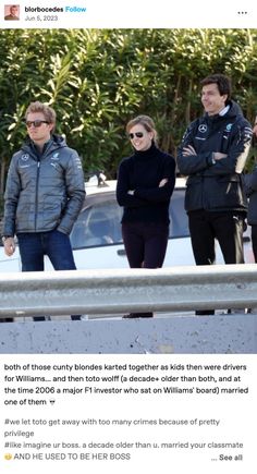 people are standing in front of a car and one person is wearing sunglasses, the other has