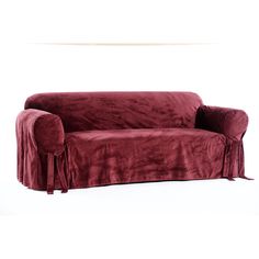 a couch covered in a red velvet cover