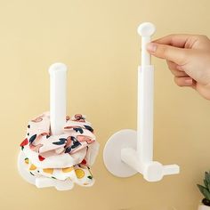 a person is holding the handle on a wall mounted toothbrush holder in their hand