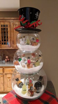 three tiered glass bowl filled with liquor bottles