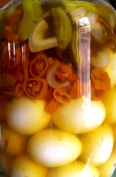 a jar filled with yellow and green vegetables