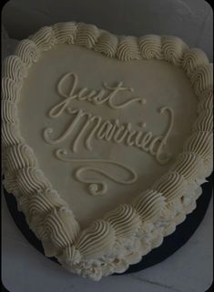 a heart shaped cake with the words just married written on it in white frosting